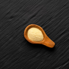 Wheat semolina in a wooden spoon - Triticum