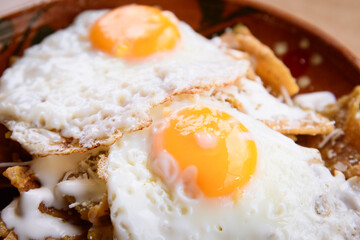 Mexican fried eggs, with chilaquiles and beans