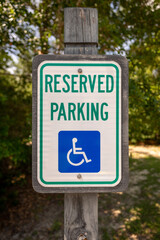 Reserved parking sign near accessible area in a public space during daylight hours