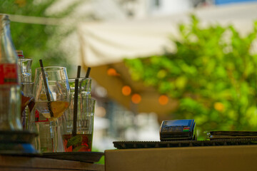 street restaurant in the summer with glasses, bottles and a EC Cash Visa Mastercard payment terminal