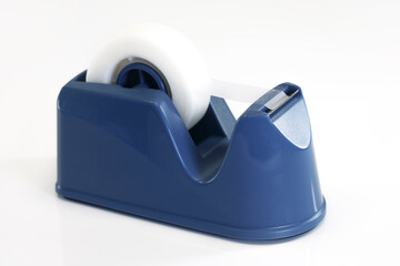 Blue tape dispenser resting on white background