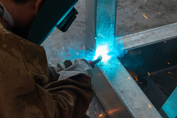 worker welding in a factory at horizonal composition