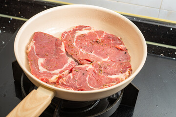 cooking steaks with pan at home