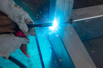 worker welding in a factory at horizonal composition