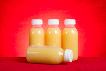 homemade bottle of mung bean water chestnut beverage on red background at horizontal composition