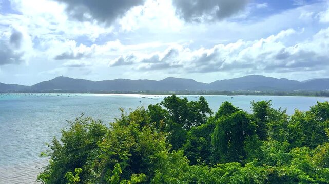 Beautiful view from Kao Khad next to Cape Panwa on the island of Phuket Thailand. Views of the turquoise Blue waters of the Andaman Sea and small islands off the coat of Phuket