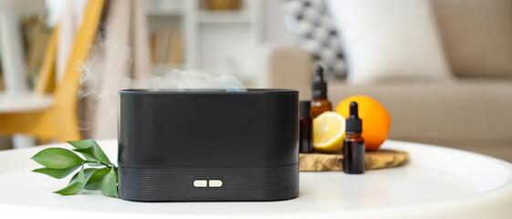 Air humidifier with essential oils and citruses on table in living room, closeup