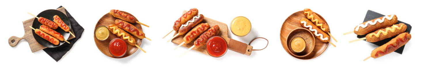 Set of tasty corn dogs on white background, top view