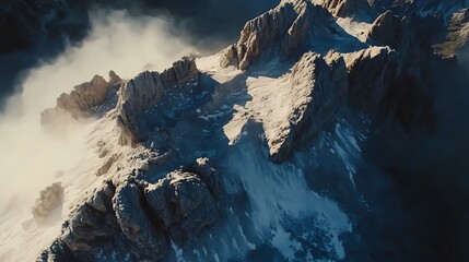Snowy Rocky Mountain Range Aerial View with Fog and Dramatic Lighting