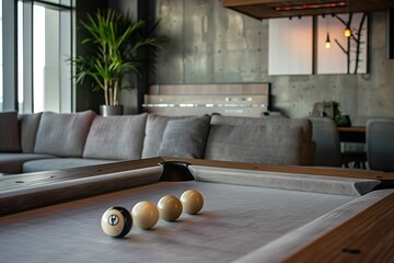 Modern billiards room with a pool table and billiard balls for entertainment and recreation