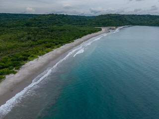 Stunning  aerial view of Playa Cabuyal, Costa Rica — a hidden gem with pristine sand, turquoise waters, and untouched nature, perfect for eco-tourism and beach lovers.
