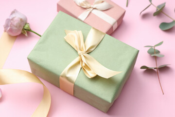 Gift boxes and beautiful rose on pink background. International Women's Day