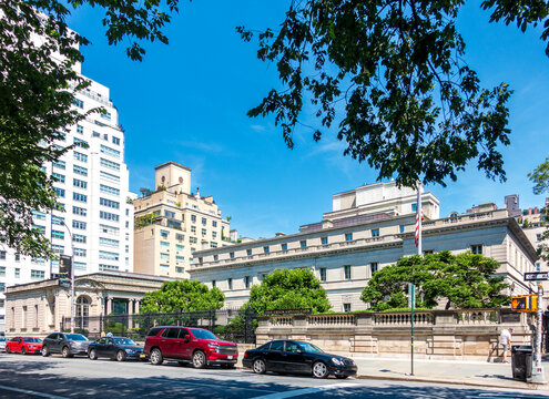 New York, NY - US - Jul 6 2025 The Frick Collection, seen from Fifth Avenue, stands as a stately Beaux-Arts mansion framed by manicured trees, classical balustrades, and elegant limestone fa&ccedil;ades.