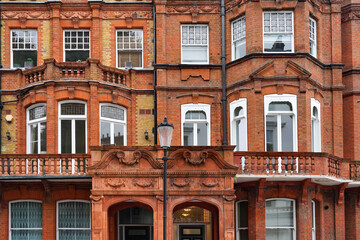 ornate brick apartment buildings with bay windows  and  in London, England