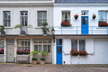 Mews houses with cobblestone lane in London, England