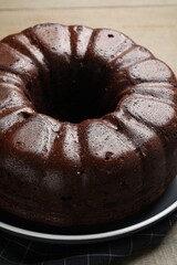 Tasty chocolate bundt cake on wooden table, closeup