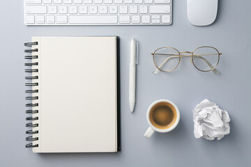 Notebook, pen, crumpled paper, coffee, computer keyboard and mouse on grey background, flat lay