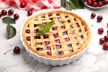 Tasty cherry pie and berries on white marble table, closeup