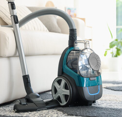 One vacuum cleaner on floor indoors. Household appliance