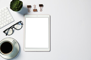 Tablet, stationery, computer keyboard, glasses, coffee and floral decor on white background, flat...