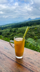 indonesian herb drink called wedang sereh with mountain background