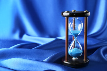 Crystal hourglass on blue background