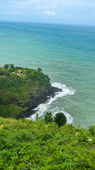 Scenic tropical beach Clear turquoise water, white sandy shore, and rocky cliffs make it a stunning and peaceful coastal landscape