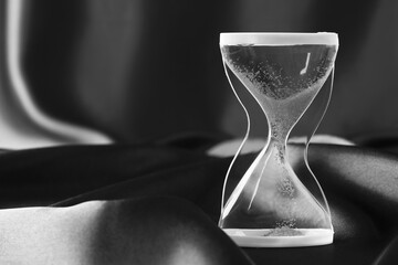 Crystal hourglass on dark  background