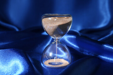 Crystal hourglass on blue background
