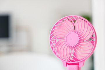 Small electric fan on blurred background, closeup