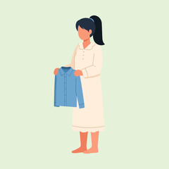 Standing Woman Holding Blue Shirt in Light White Dress