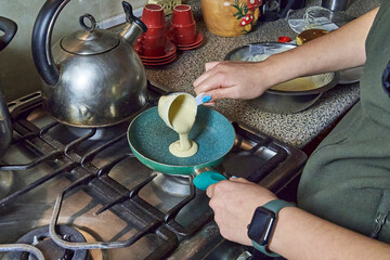 Homemade pancakes prepared in a home kitchen with completely homemade preparation. Dessert cooking concept