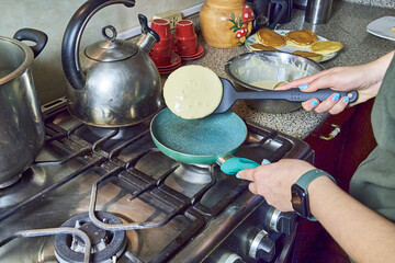 Homemade pancakes prepared in a home kitchen with completely homemade preparation. Dessert cooking concept