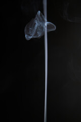 Abstract figure created by white smoke on an isolated black background to stimulate the subconscious with truly beautiful shapes