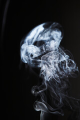 Abstract figure created by white smoke on an isolated black background to stimulate the subconscious with truly beautiful shapes