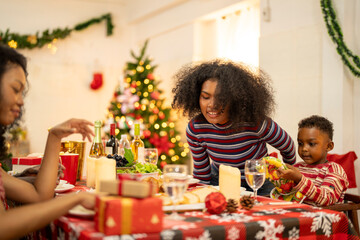 A cheerful holiday dinner scene with a diverse family enjoying a festive meal. Christmas...