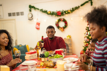 A warm Christmas family dinner with a father serving food to his young child, surrounded by festive decorations, a Christmas tree, and a holiday table spread. Joyful and cozy holiday atmosphere.