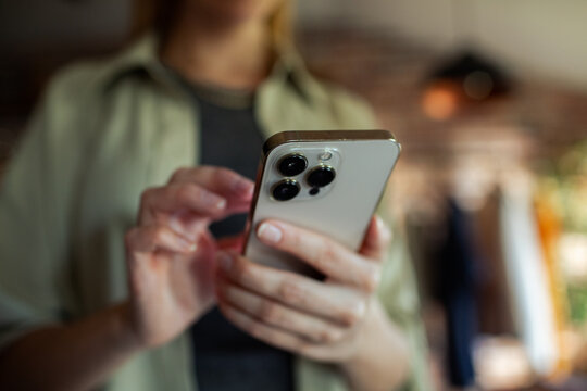 Close up of woman using smartphone indoors