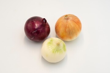 Assorted whole onions isolated on white background