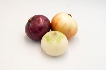 Assorted whole onions isolated on white background