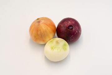 Assorted whole onions isolated on white background