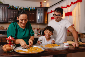 Happy family baking cookies in the kitchen during the holidays