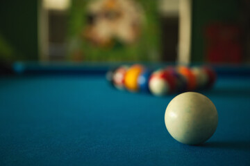A player prepares to break on a neatly arranged pool table