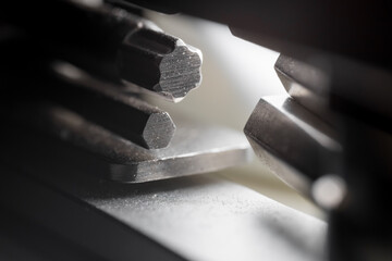 Close up view of folded metallic tool bits shallow depth of field.