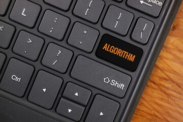 Keyboard Featuring Custom Algorithm Key on Wooden Surface