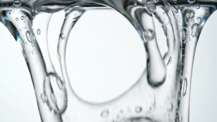 Close-up of transparent cosmetic gel flowing smoothly on white background. Glossy, clear texture with elegant fluid motion. - Powered by Adobe