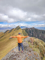 Fototapeta premium Pichincha Province, Quito, Ecuador - July 5, 2025: Tourist at the summit of Pasochoa Volcano, located in the Pasochoa Wildlife Refuge. The extinct volcano is 4,200 meters high.