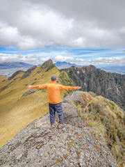 Naklejka premium Pichincha Province, Quito, Ecuador - July 5, 2025: Tourist at the summit of Pasochoa Volcano, located in the Pasochoa Wildlife Refuge. The extinct volcano is 4,200 meters high.