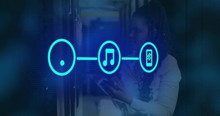 IT technician scrolling tablet for network monitoring, causing pulsing wifi music smartphone icons - Powered by Adobe
