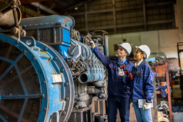 Heavy transportation industry engineers in steel metal manufacturing maintenance factory train engineer. Asian female worker and caucasian engineer.

